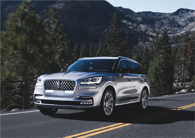 A 2023 Lincoln Aviator® Grand Touring SUV being driven on a winding road to demonstrate the capabilities of all-wheel drive | Parks Lincoln of Tampa in Tampa FL