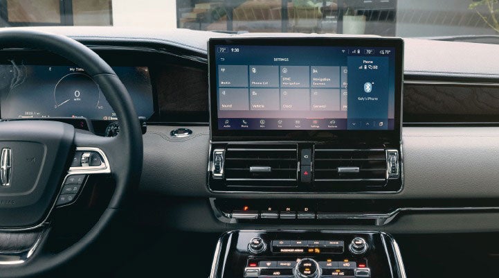 The front cabin of a 2023 Lincoln Navigator SUV shows off ergonomic design and the 13.2-inch LCD center touchscreen displaying the SYNC 4 interface.