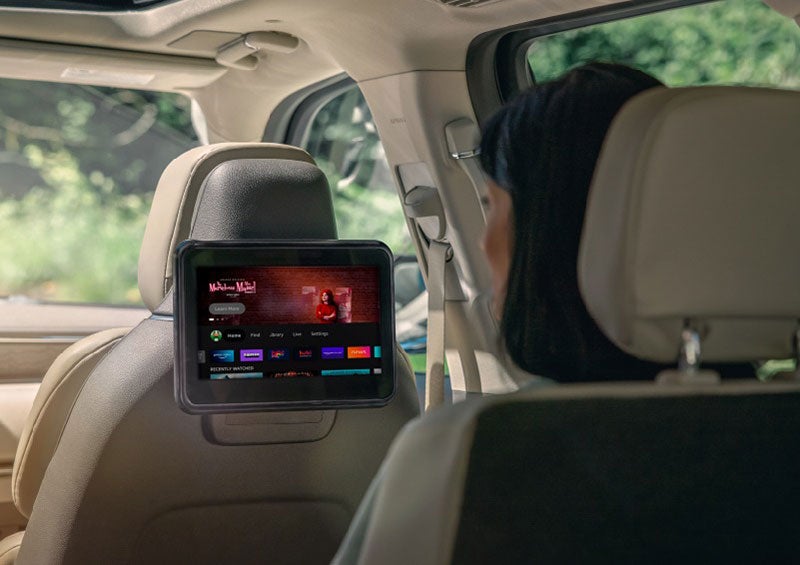 A person is seated in a 2023 Lincoln Nautilus SUV viewing an available entertainment screen. | Parks Lincoln of Tampa in Tampa FL