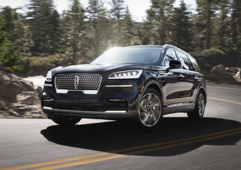 A Lincoln Aviator® SUV is being driven on a winding mountain road | Parks Lincoln of Tampa in Tampa FL