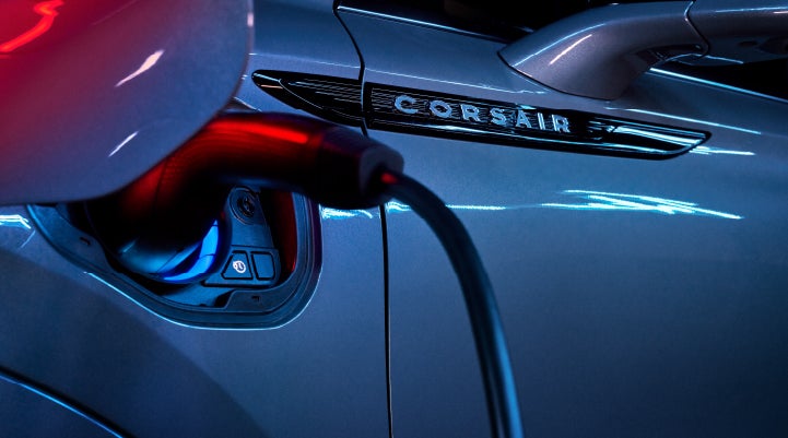 A charger plugged into the charging port of a 2024 Lincoln Corsair® Plug-in Hybrid model. | Parks Lincoln of Tampa in Tampa FL