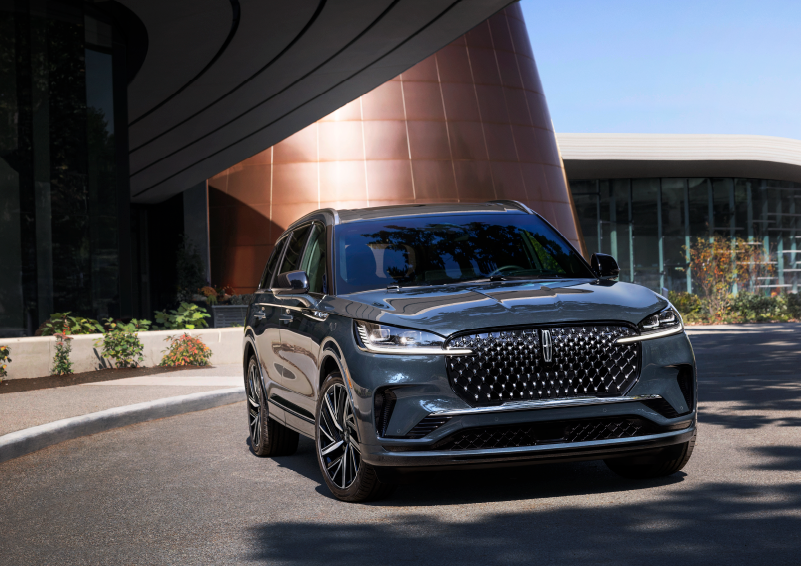 A gray 2025 Lincoln Aviator® SUV is parked outside a modern building with the sun shining. | Parks Lincoln of Tampa in Tampa FL