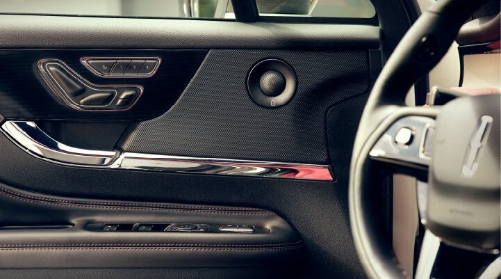A Revel® audio speaker is shown in the driver's side door of a 2025 Lincoln Corsair® SUV. | Parks Lincoln of Tampa in Tampa FL