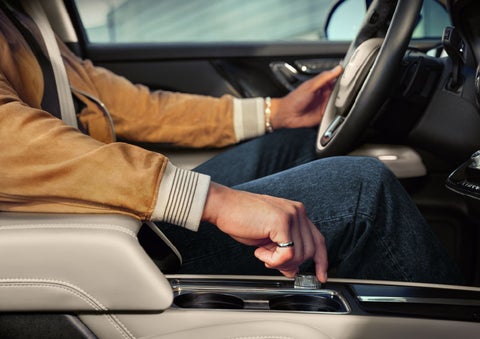 The driver of a 2024 Lincoln Corsair® SUV is shown selecting the drive mode. | Parks Lincoln of Tampa in Tampa FL