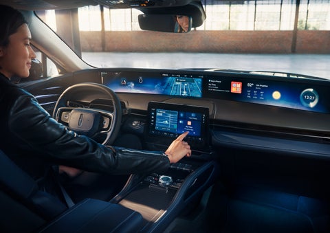The driver of a 2025 Lincoln Nautilus® SUV interacts with the center touchscreen. | Parks Lincoln of Tampa in Tampa FL