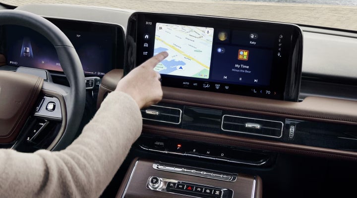 A person is tapping the center display touchscreen of a 2026 Lincoln Aviator® SUV. | Parks Lincoln of Tampa in Tampa FL