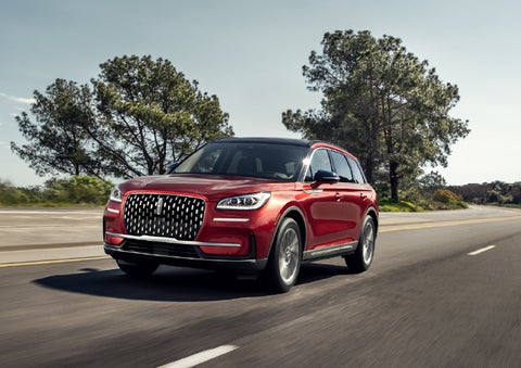 A 2026 Lincoln Corsair® SUV is shown being driven on a country road. | Parks Lincoln of Tampa in Tampa FL