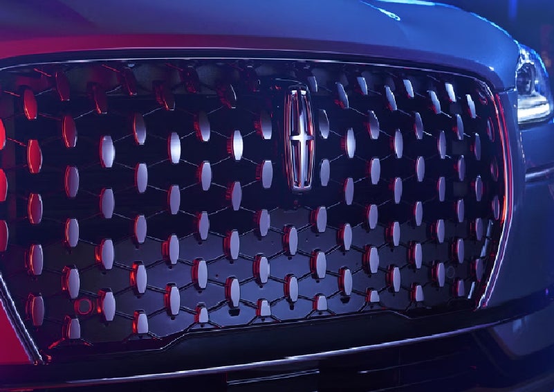 The grille of a 2025 Lincoln Corsair&reg; SUV reflects neon light at night. | Parks Lincoln of Tampa in Tampa FL