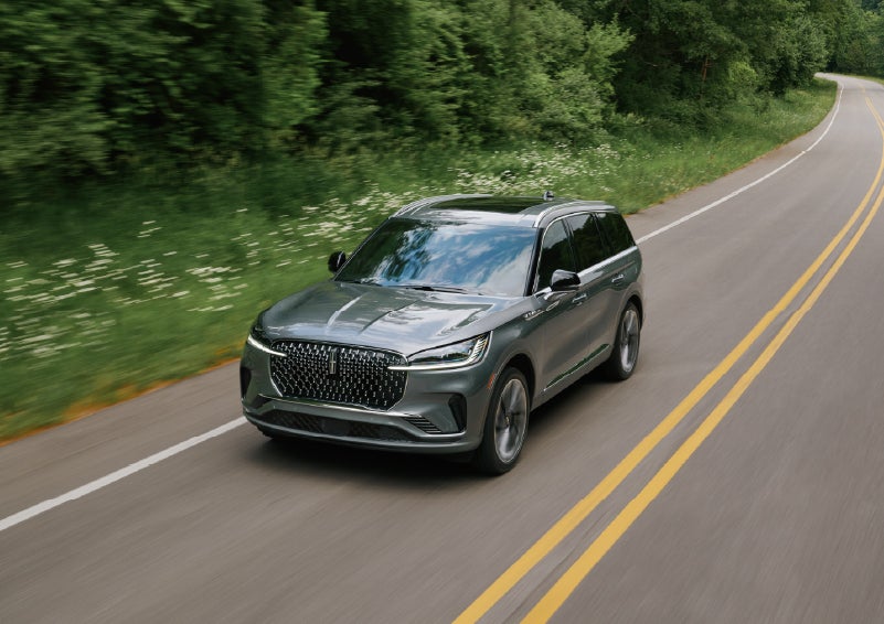 A 2027 Lincoln Aviator® SUV is being driven down a road. | Parks Lincoln of Tampa in Tampa FL