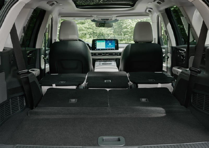 A rear to front view of the interior of a 2027 Lincoln Aviator® Black Label™ SUV shows the third and second rows folded flat | Parks Lincoln of Tampa in Tampa FL