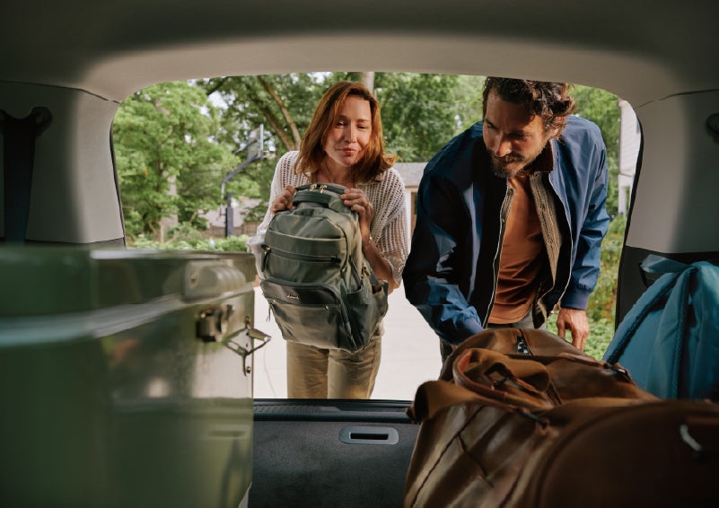 A couple loads luggage into the rear of a 2027 Lincoln Aviator® Black Label™ SUV..e 202 | Parks Lincoln of Tampa in Tampa FL